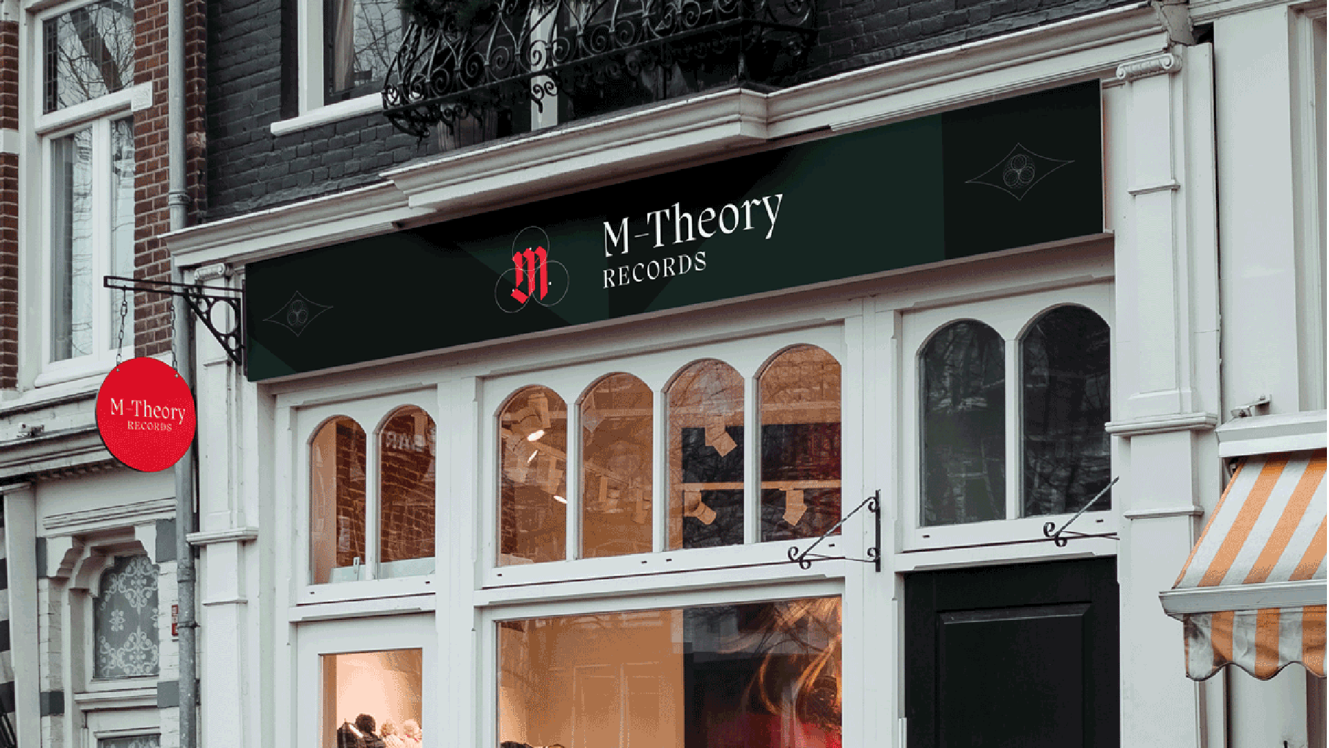An image of storefront with a red hanging sign with typographic logo. there is also a large black sign above the door with a red logo and white typogarphy. Design made in adobe Illustrator